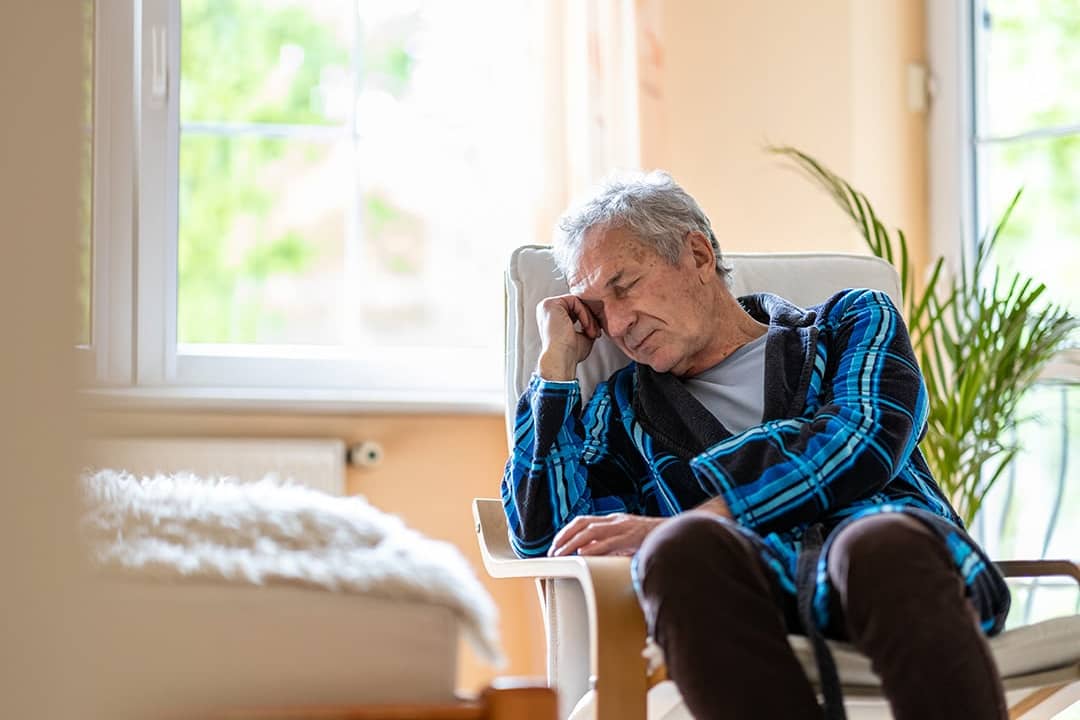 A senior man at home feeling depressed.